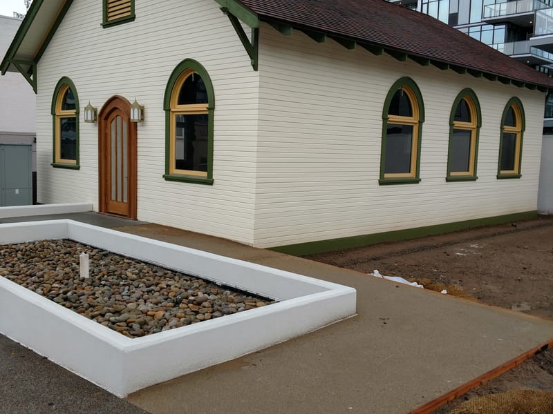 East Village Church after restoration — white siding and green trim fully restored, 2018